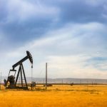 A nodding donkey pumps crude up from the ground on an oil field